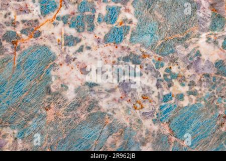 Turquoise marble with beige flecks and rusty veins, polished mineral cut. Stock Photo