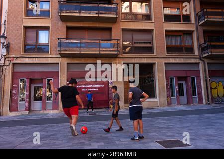 Pamplona, Spain - July, 31: Teenage boy soccer player taking penalty kck on the street Stock Photo