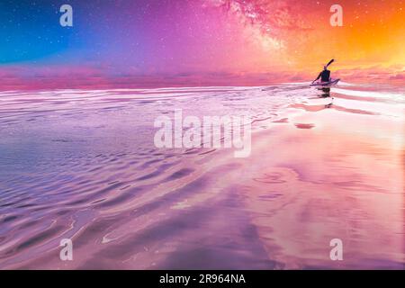 person in a canoe on the heaven . person is seen in the middle of a vast ocean Stock Photo