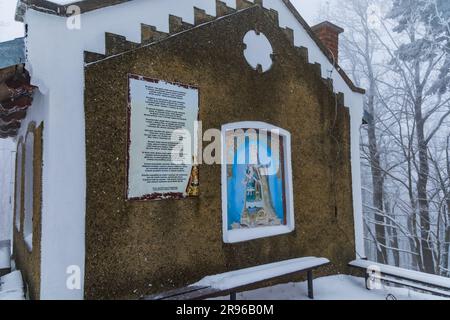 Bardo, Poland - January 2023: Mountain chapel of Our Lady of Weeping in Bardo mountains full of snow and fog at winter Stock Photo