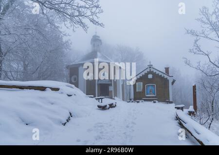 Bardo, Poland - January 2023: Mountain chapel of Our Lady of Weeping in Bardo mountains full of snow and fog at winter Stock Photo