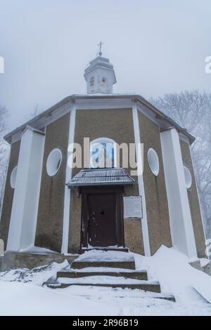 Bardo, Poland - January 2023: Mountain chapel of Our Lady of Weeping in Bardo mountains full of snow and fog at winter Stock Photo