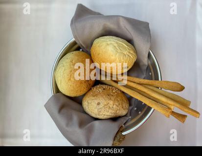 Basket with different types of fresh breads on the table.  Stock Photo