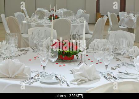 Festively laid table in a restaurant for a family celebration, napkins and flower arrangements, Germany Stock Photo