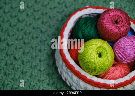 Yarn for crocheting. Top view, web banner with copy space. Concept hobby of handmade needlework from home. Several woolen multicolored balls of thread Stock Photo