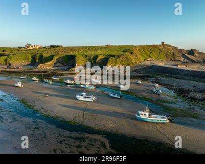 Fishing boats on the ground at low tide in Bude Bay, Compass Point on the horizon to the right, North Cornwall, England, Great Britain Stock Photo