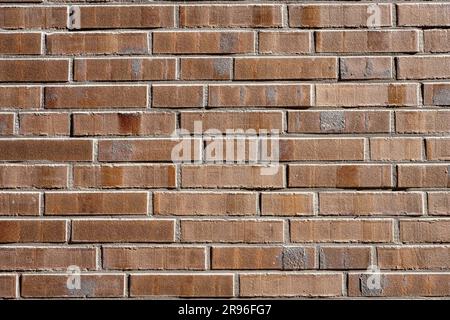 Background made of a wall of brown bricks Stock Photo