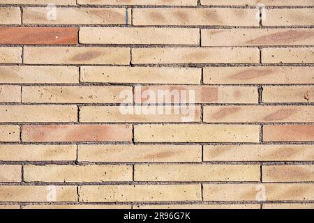 Background from a wall of beige clinker bricks Stock Photo