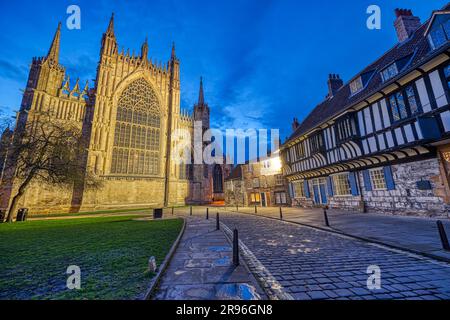 The back of York Minster and some half-timbered houses at dusk Stock Photo