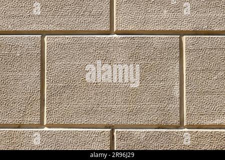 Background of a wall with rectangular beige stone slabs Stock Photo