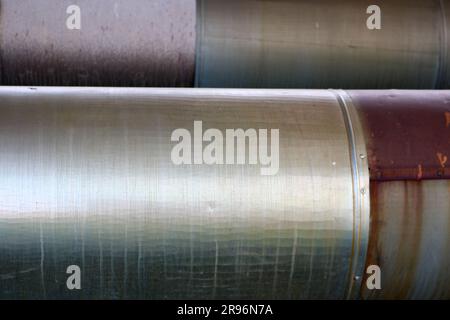 Two large pipes in isolation from tin on the oil refinery, petrochemical, chemical plant background, texture. Stock Photo