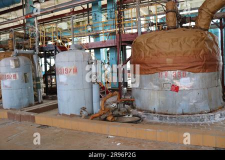 Large iron heat exchanger, tank, reactor, distillation column in thermal insulation of fiberglass and mineral wool of galvanized steel in the industri Stock Photo