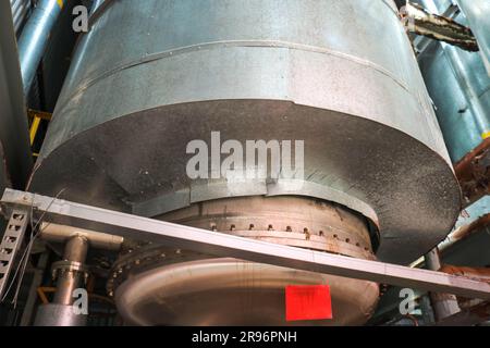 Large iron heat exchanger, tank, reactor, distillation column in thermal insulation of fiberglass and mineral wool of galvanized steel in the industri Stock Photo