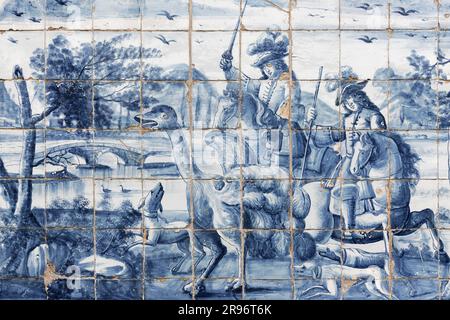 Azulejo, two men on horseback chasing ostrich, painted wall tiles by Valentim de Almeida, 18th century, Se do Porto cloister, Porto, Portugal Stock Photo