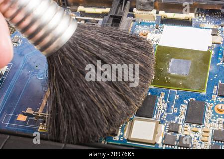 Cleaning the motherboard from dust and debris with a brush Stock Photo ...