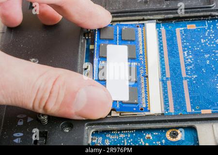 cyber data attack concept : broken laptop ,crash motherboard ,memory hard disk electronic hardware problems on white desktop ,backup information maint Stock Photo
