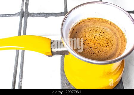 https://l450v.alamy.com/450v/2r977w1/kitchen-interior-coffee-making-in-yellow-turkey-turk-on-gas-stove-coffee-with-foam-2r977w1.jpg