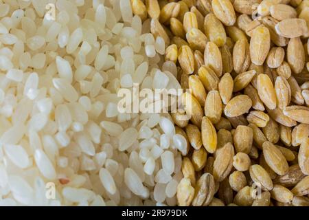 half raw rice half wheat grains background Stock Photo - Alamy