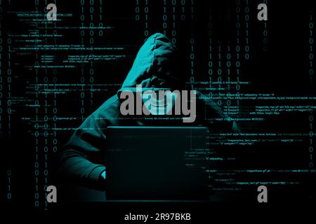 Cyber attack. Anonymous hacker working with laptop on black background. Different digital codes around him Stock Photo