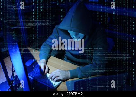 Cyber attack. Anonymous hacker working with computers and breaking system to steal information indoors. Different digital codes around him Stock Photo