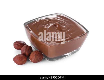 Bowl with delicious chocolate paste and hazelnuts on white background Stock Photo