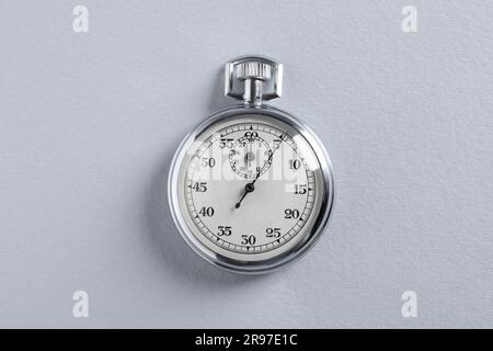 Vintage timer on light grey background, top view. Measuring tool Stock Photo