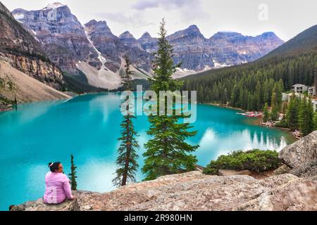 Banff, Canada, August 28th 2022 - A Tourist takes in the stunning view of the aquamarine Lake Moraine near Banff in the Canada rockies Stock Photo