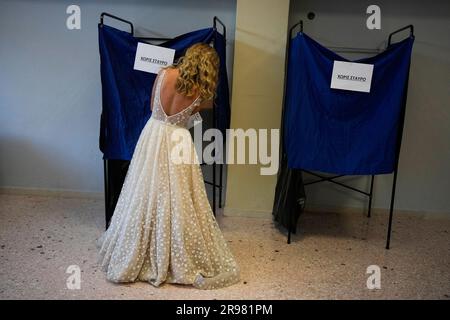 A woman wearing her just married wedding dress votes at a polling station in Athens Greece Sunday June 25 2023. Polls have opened in Greece for the second general election in less