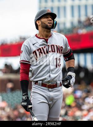 Arizona Diamondbacks left fielder Lourdes Gurriel Jr. (12) throws the ball  to Diamondbacks shortstop Geraldo Perdomo, left, after making a catch on a  fly ball hit by Seattle Mariners' Cal Raleigh during