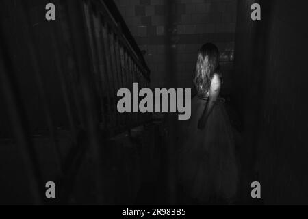 Scary ghost halloween theme, horror woman in white dress with long hair in haunted house Stock Photo