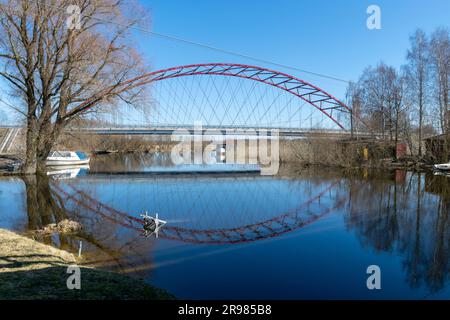 Beautiful spring landscape with Ema river entering Lake Võrtsjärv in Estonia, bridge over river, reflections in calm river water Stock Photo