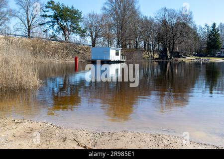 Beautiful spring landscape with Ema river entering Lake Võrtsjärv in Estonia, reflections in calm river water Stock Photo