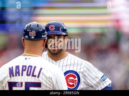 Chicago Cubs' Seiya Suzuki, left, is congratulated by first base coach Mike  Napoli after hitting a single against the San Francisco Giants during the  eighth inning of a baseball game in San