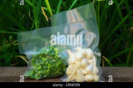 Foodsaved product. Green food in a plastic film package, removed air from inside and sealing the package. Harvest time Stock Photo