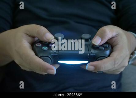 Jakarta, Indonesia - June 20, 2023 : close up of hand holding playstation stick Stock Photo