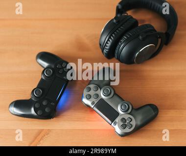 Video gaming consoles. Top view a gaming gear  on the table background. Joystick or gamepad on a table. Stock Photo