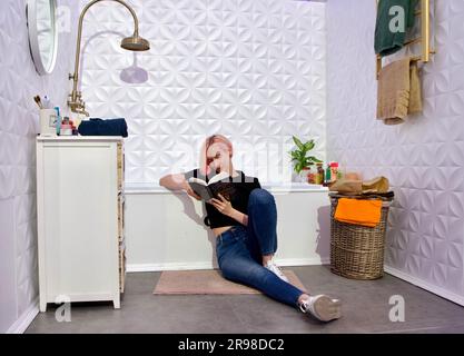 Non Exclusive: KYIV, URKAINE - JUNE 22, 2023 - A woman reads a book at an installation at the 11th International Book Arsenal Festival at the Mystetsk Stock Photo