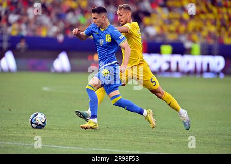 Non Exclusive: BUCHAREST, ROMANIA - JUNE 24, 2023 - Midfielder Dmytro Kryskiv (front) of Ukraine and midfielder Mihai Lixandru of Romania are seen in Stock Photo