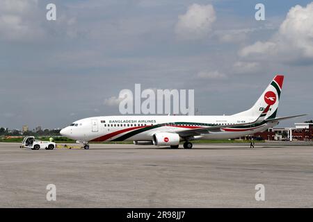 A Biman Bangladesh Airlines (BOEING 737-800) plane is seen at Hazrat Shahjalal International Airport (DAC) in Dhaka. Biman Bangladesh Airlines, commonly known as Biman, is the national flag carrier airline of Bangladesh. Established in 1972, Biman Bangladesh Airlines has its main hub at Hazrat Shahjalal International Airport in Dhaka, the capital city of Bangladesh. Biman Bangladesh Airlines plays a significant role in connecting Bangladesh with the rest of the world, contributing to the country's economic development and promoting tourism. Stock Photo