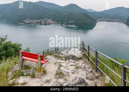 A red bench in the panoramic point called Sasso delle parole, with an incredible view from the top of Lake Lugano, Switzerland Stock Photo