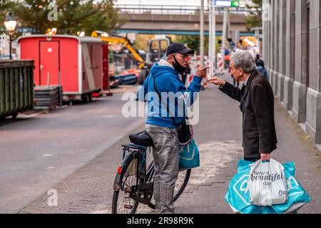 The Hague, Netherlands - October 7, 2021: Two unidentified senior men arguing in the street in The Hague, the Netherlands. Stock Photo