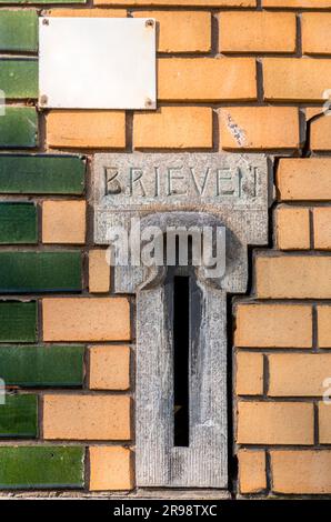 Traditional Dutch mail box whole integrated on walls or doors, found in Rotterdam, the Netherlands. Stock Photo