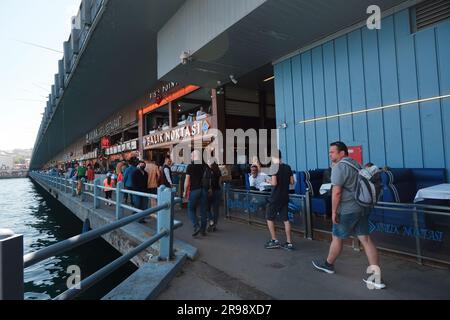 Istanbul, Turkey - May 21, 2022. Crowd of tourists on the Galata Bridge in the heart of Istanbul city, Turkey. Famous seafood area with restaurants. Stock Photo