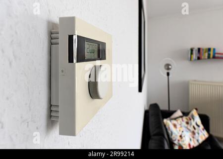 wall mounted digital indoor thermostat at 20°C Stock Photo