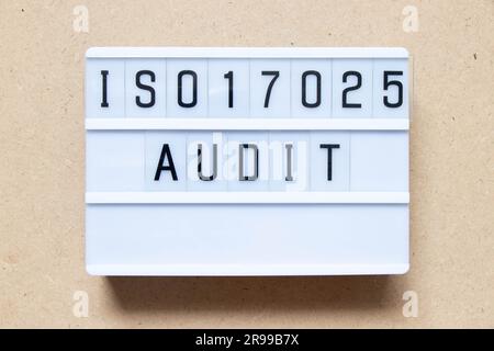 Lightbox with word ISO 17025 audit on wood background Stock Photo