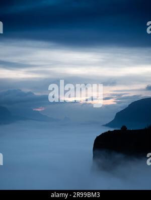 Fog fills the Columbia River Gorge below Vista House (right), pre-dawn. Near Portland, Oregon, USA. Stock Photo
