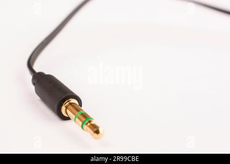 3.5mm headphone jack with wire lies on a white background isolate Stock Photo