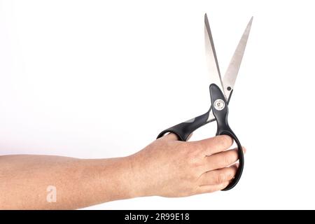 hand with black scissors in white background isolate Stock Photo