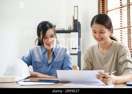 Engineering construction concept, Two female engineers is discussing construction and taking notes. Stock Photo