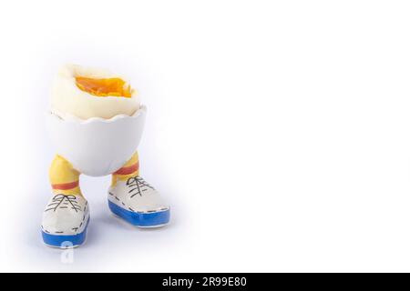 boiled egg open half in stand in the form of legs isolate Stock Photo
